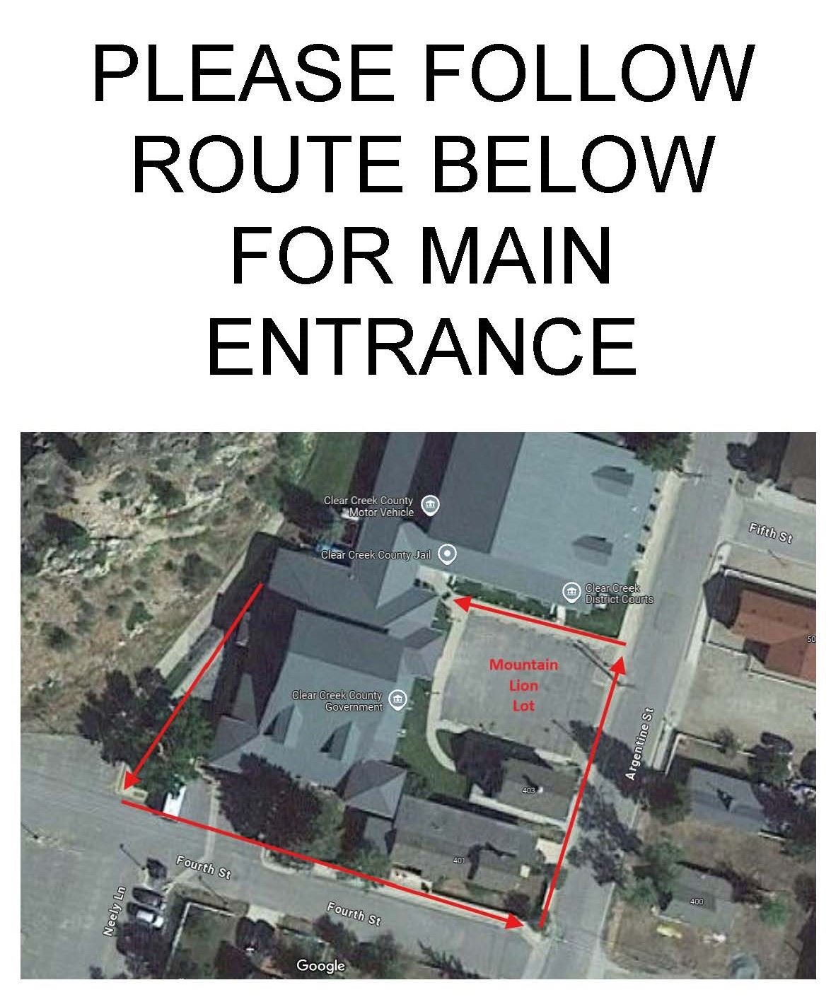 A sign that asks people to go to the front door to enter the County Building